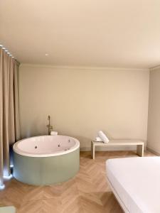 a bathroom with a tub in the middle of a room at AT Boutique Alma in Alicante +131 photos