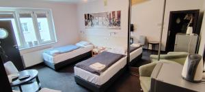 a room with three beds and a mirror at Pentagos in Poznań