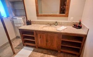 a bathroom with a sink and a mirror at Casa Verde Río in Rio de Janeiro