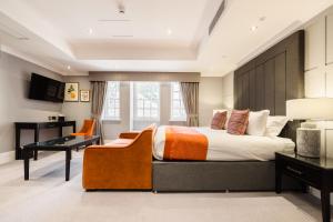 a bedroom with a large bed and a desk at Vale Resort in Hensol +66 photos