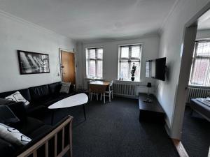 a living room with a couch and a table at Id069 Englandsgade 13, 1th in Esbjerg