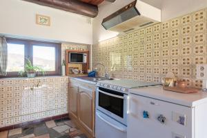 a kitchen with a sink and a stove at Gîte de la Séoube in Campan +16 photos