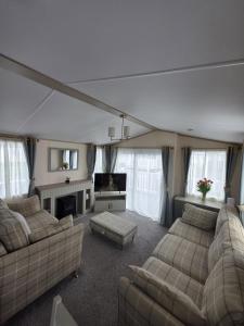a large living room with couches and a tv at 8 Berth Caravan - Blue Dolphin - Filey in Gristhorpe