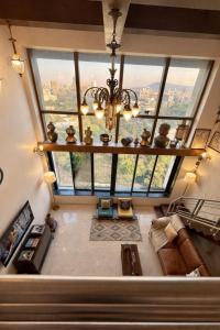 an overhead view of a living room with a large window at Pet Friendly Spacious 3 BHK Penthouse in Mumbai