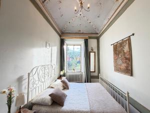a bedroom with a white bed and a ceiling at Bed & Blessing / Casa Borgo in Locarno