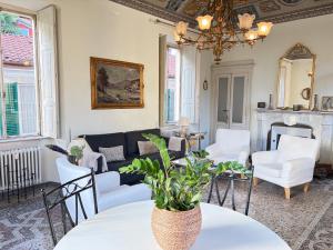 a living room with a couch and a table and chairs at Bed & Blessing / Casa Borgo in Locarno