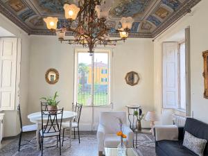 a living room with a table and a chandelier at Bed & Blessing / Casa Borgo in Locarno +91 photos