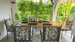 a wooden table and chairs in a room at Guest House - Heaven in Byala
