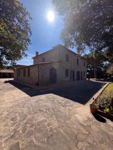 a large brick building with the sun in the sky at Maison Antoinette in San Vincenzo +32 photos