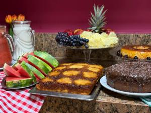 a table topped with different types of cakes and fruit at Domus Hotel Trindade - Canaã dos Carajás in Canaã dos Carajás