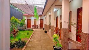 a hallway of a building with plants in it at Hotel Shandira in Taliwang +8 photos