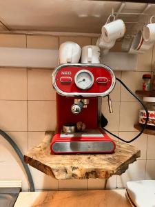 a red mixer sitting on a wooden shelf at Apartment 16 in Probištip