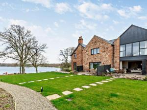 a brick house with a lawn and a lake at 2 Bed in Brampton oc-91822 in Brampton