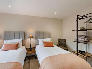 a bedroom with two beds and a chair at 2 Bed in Brampton oc-91822 in Brampton