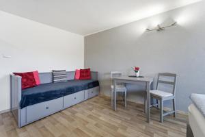 a bedroom with a bed and a table and chairs at Apartmán Plasy in Plasy