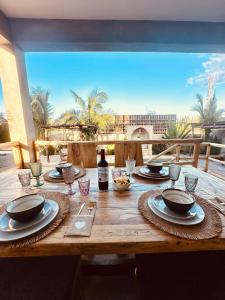 a wooden table with plates of food on it at Uroa Sunset Bliss in Uroa