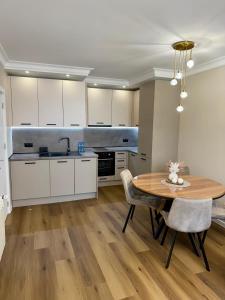 a kitchen with a wooden table and a dining room at Luxury Apartment Sofia in Sofia