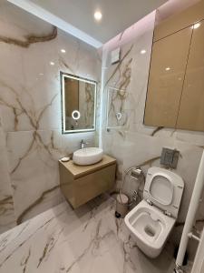 a marble bathroom with a toilet and a sink at Luxury Apartment Sofia in Sofia +12 photos