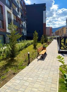 a bench on a sidewalk next to a building at Luxury Apartment Sofia in Sofia
