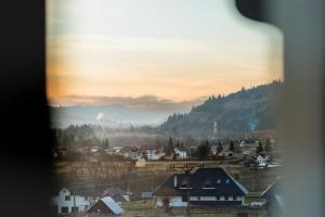 a view from a window of a town with a mountain at Pe Coastă in Cozăneşti