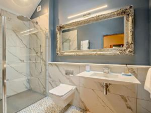a bathroom with a toilet and a sink and a mirror at 1 Bed in Lockerbie oc-93110 in Lockerbie +11 photos