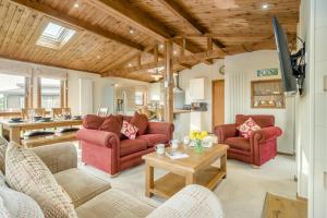 a living room with two couches and a table at 3 Bed in Whitby oc-wa057 in Runswick