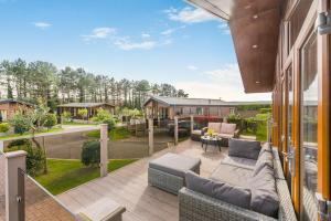 an outdoor patio with a couch and chairs on a house at 3 Bed in Whitby oc-wa057 in Runswick
