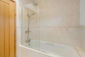 a bathroom with a bath tub with a shower at 3 Bed in Whitby oc-wa057 in Runswick +28 photos