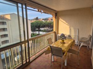 a balcony with a table and chairs on a balcony at T3 spacieux,2chambres,clim,piscine in Sainte-Maxime