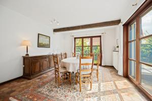 a dining room with a table and chairs at Bretoenselaan 5 in De Haan +7 photos