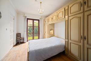a bedroom with a white bed and a window at Bretoenselaan 5 in De Haan
