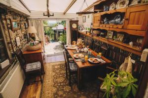 a kitchen with a table and chairs in a room at Coachman's Cottage B & B in Plymouth