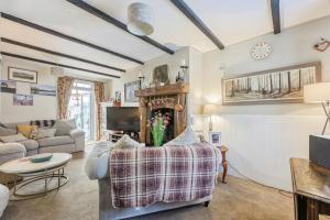 a living room with a couch and a fireplace at Coachman's Cottage B & B in Plymouth