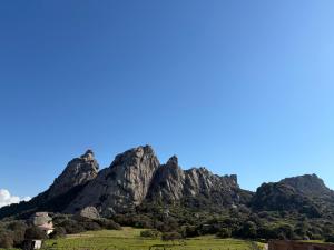 a mountain range with a green field in front of it at A Santa Trinita in Bonifacio +120 photos