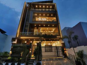 a tall building with lights on top of it at Palette Oraya Greens by CheckIn, Kathauta Lake, Lucknow in Chinhat