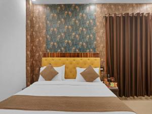 a bedroom with a large bed and a curtain at Palette Oraya Greens by CheckIn, Kathauta Lake, Lucknow in Chinhat +46 photos