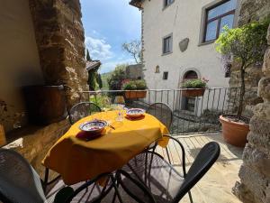 a table with a yellow table cloth on a patio at La Loggia di Montefienali in Gaiole in Chianti