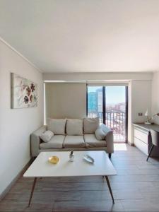 a living room with a couch and a table at Centro Vista Al Mar san Martin Coliving in Antofagasta +43 photos