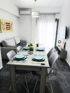 a dining room table with chairs and a couch at Seawaves in Ierissos +12 photos