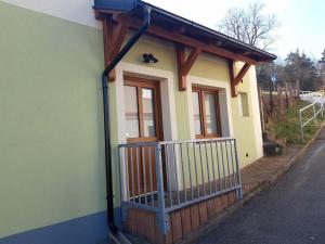a small house with a gutter at Apartmán Plasy in Plasy +4 photos