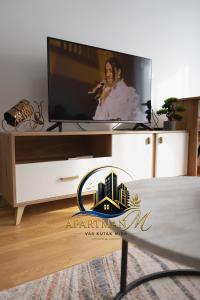 a living room with a flat screen tv on a stand at ApartmanMFoca in Foča