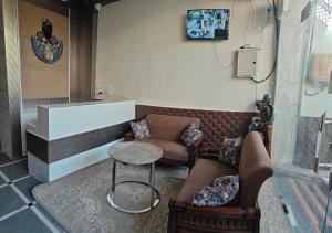 a living room with a couch and a table at Blue Breeze in Haridwār