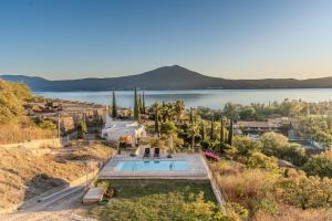 an aerial view of a house with a swimming pool and a lake at Casa Ambar Luxury Lake View Villa Pool Design in San Juan Cosalá