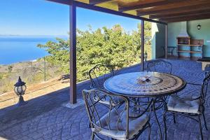 a table and chairs on a patio with a view of the ocean at Casa Tia Rosalia in Tijarafe