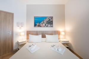 a bedroom with a bed with two towels on it at Panoramic Rooms Salerno in Salerno