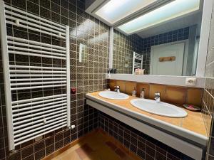 a bathroom with two sinks and a mirror at La Fermette du Patural in Ramonchamp +18 photos