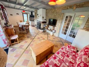 a living room with a couch and a table at La Fermette du Patural in Ramonchamp