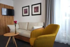a living room with a couch and a chair at Strandhotel Seehof in Überlingen