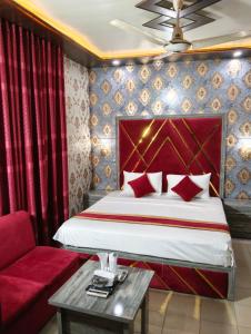 a hotel room with a bed and a couch at Star Hotel Lahore in Lahore +15 photos