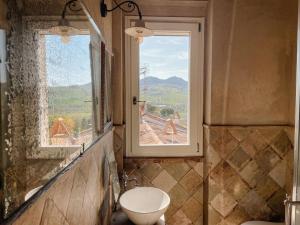 a bathroom with a toilet and a window at La chesa de Prit in Verucchio +78 photos